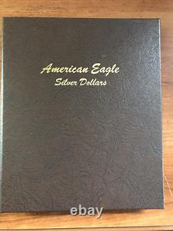 1986-2020 Lot de 35 pièces de dollars American Eagle en qualité brillant universel (BU) dans un album Delux Dansco.